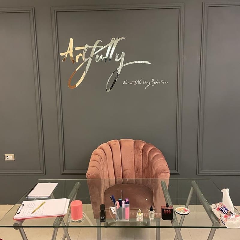 Metallic 3D logo reception wall branding for Artfully Event & Wedding Productions on paneled wall