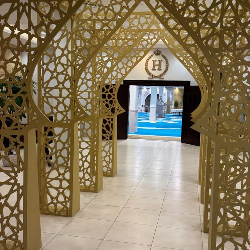 Stunning corridor of gold CNC-cut Islamic geometric archways installed at H Venue event hall