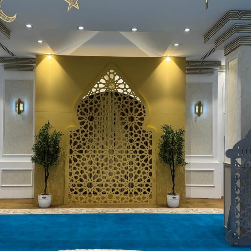 Grand hall Ramadan installation with CNC-cut decorative lanterns, geometric gate, and crescent ceiling accents at H Venue